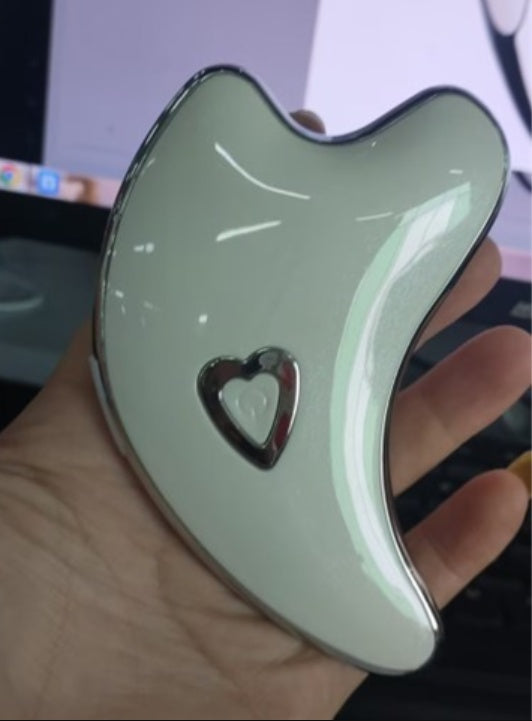 Green electric facial massager gua sha tool with heart logo and control panel
