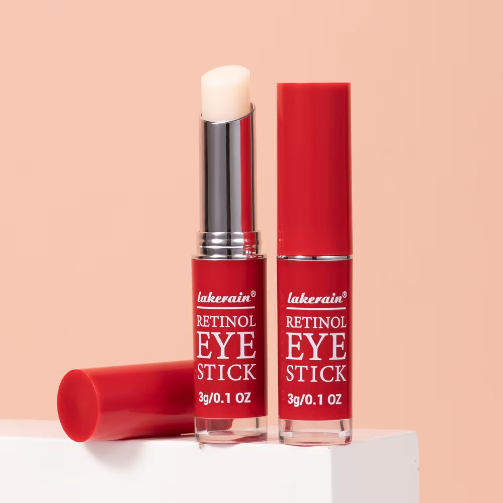 Red retinol eye stick with white balm cap, upright and lying