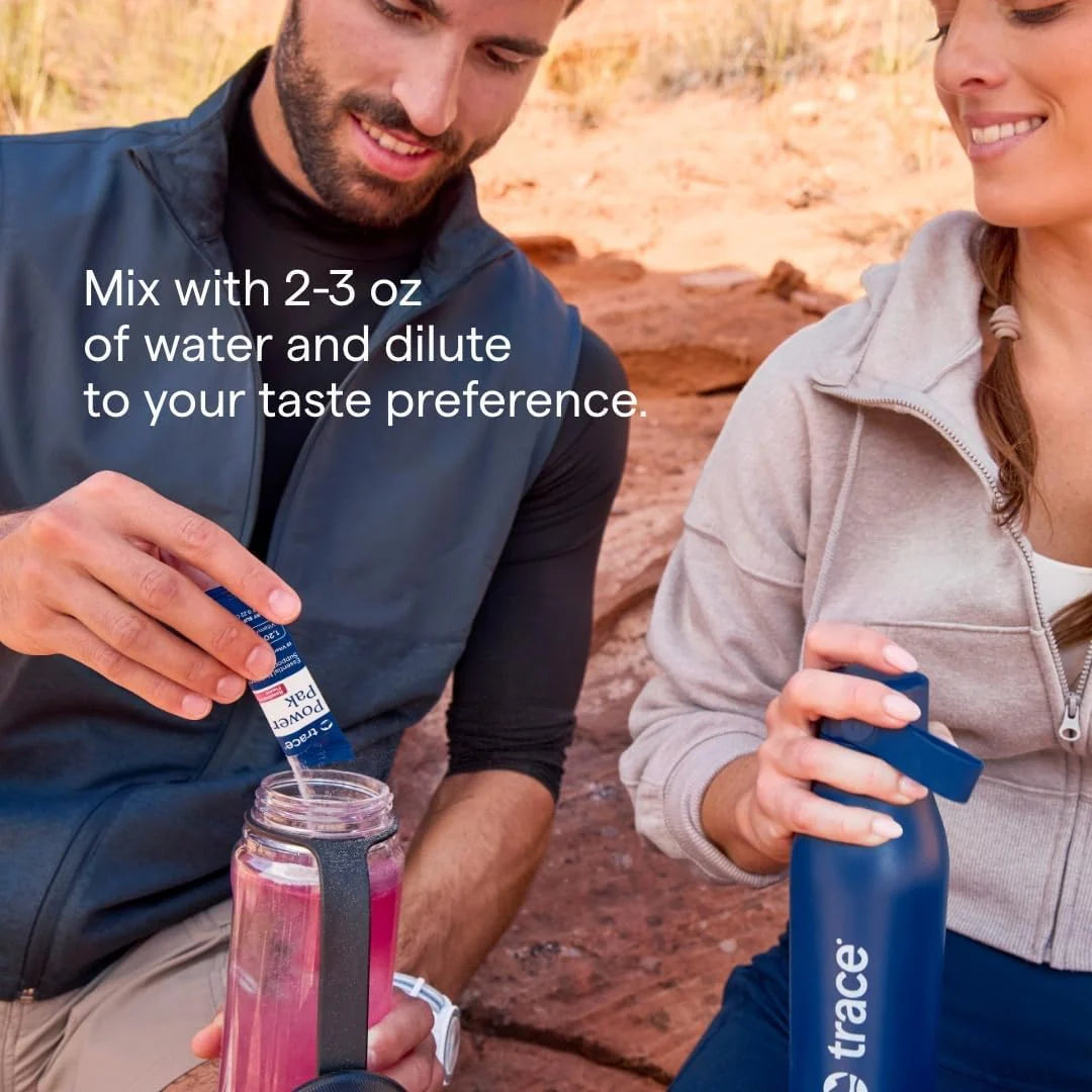 Blue Power Pak electrolyte packet being opened or squeezed while mixing drink