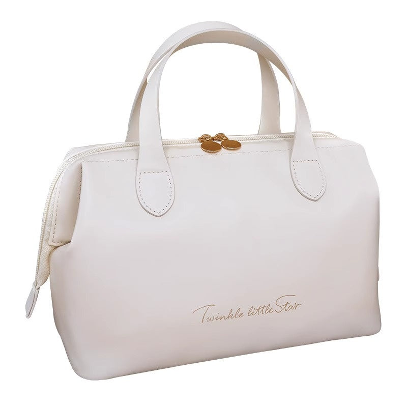 Cream beauty organizer bag with double handles and gold-tone clasp on top