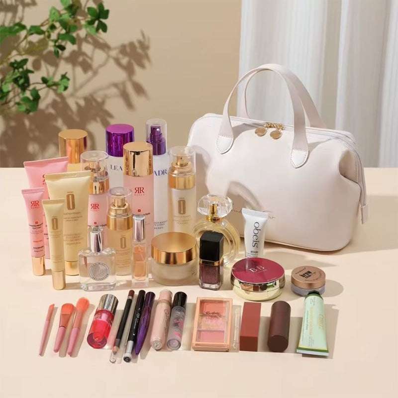 Cream beauty organizer bag with gold-tone top clasp and makeup bottles and tubes nearby