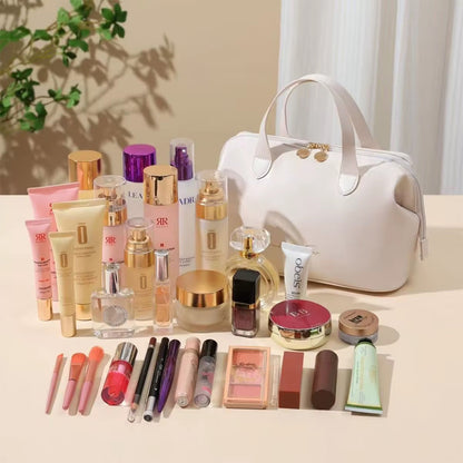 Cream beauty organizer bag with gold-tone top clasp and makeup bottles and tubes nearby