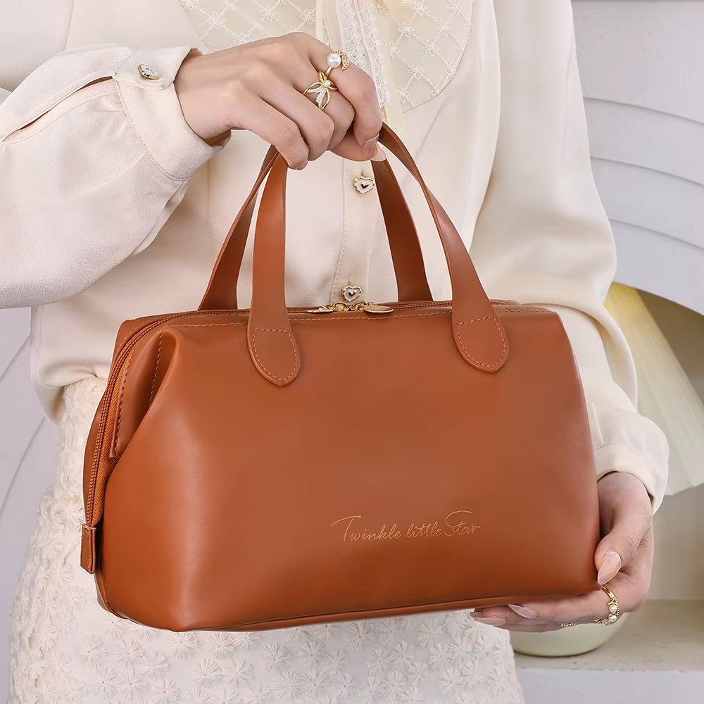 Brown beauty organizer bag with double top handles and front zipper pocket