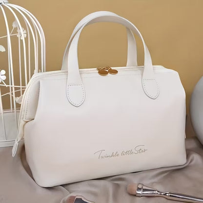Cream beauty organizer bag with double handles and gold-tone top clasp