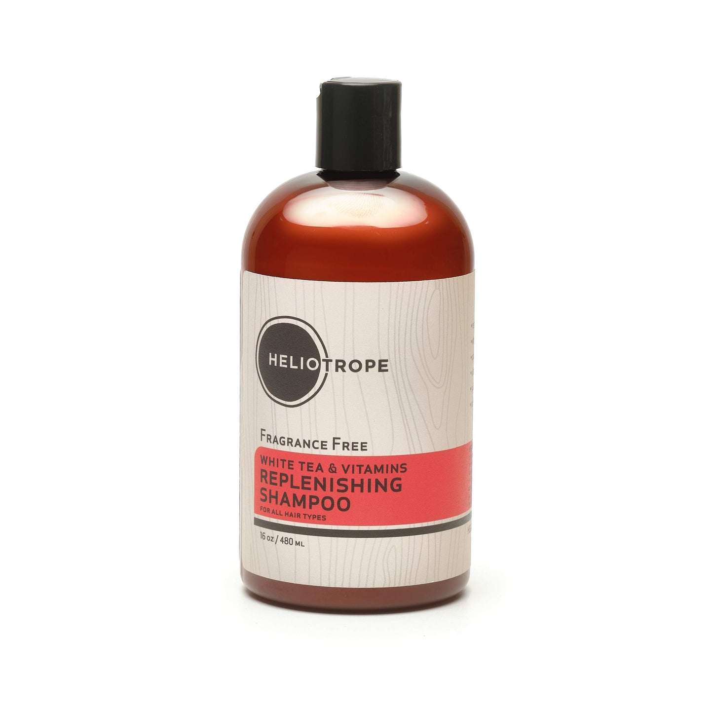 Shampoo bottle, fragrance-free; white tea & vitamins replenishing; amber liquid, black cap.